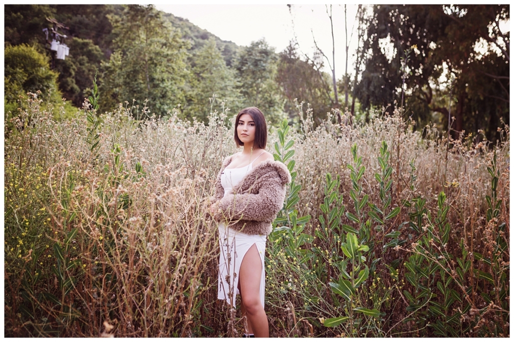 High school senior portraits in a field in Laguna Beach