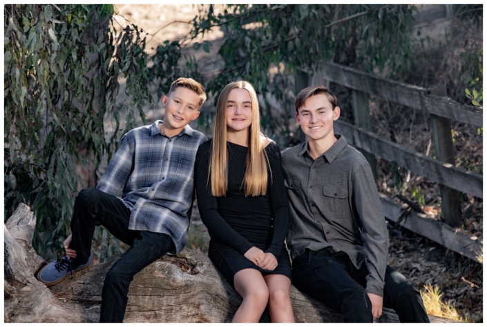 Three kids posing in Laguna Hills for a family photography shoot.
