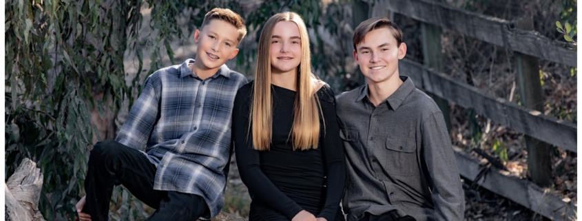 Three kids posing in Laguna Hills for a family photography shoot.
