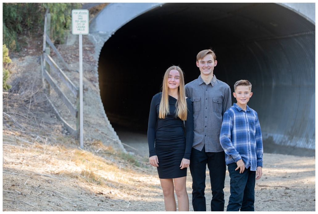 Three older siblings posing for a family portrait session in Orange County.