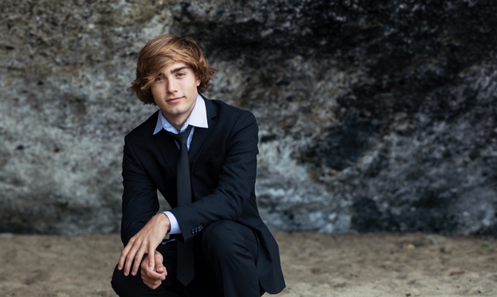 High School Senior guy photographed at the beach in a suit.