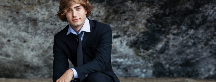 High School Senior guy photographed at the beach in a suit.