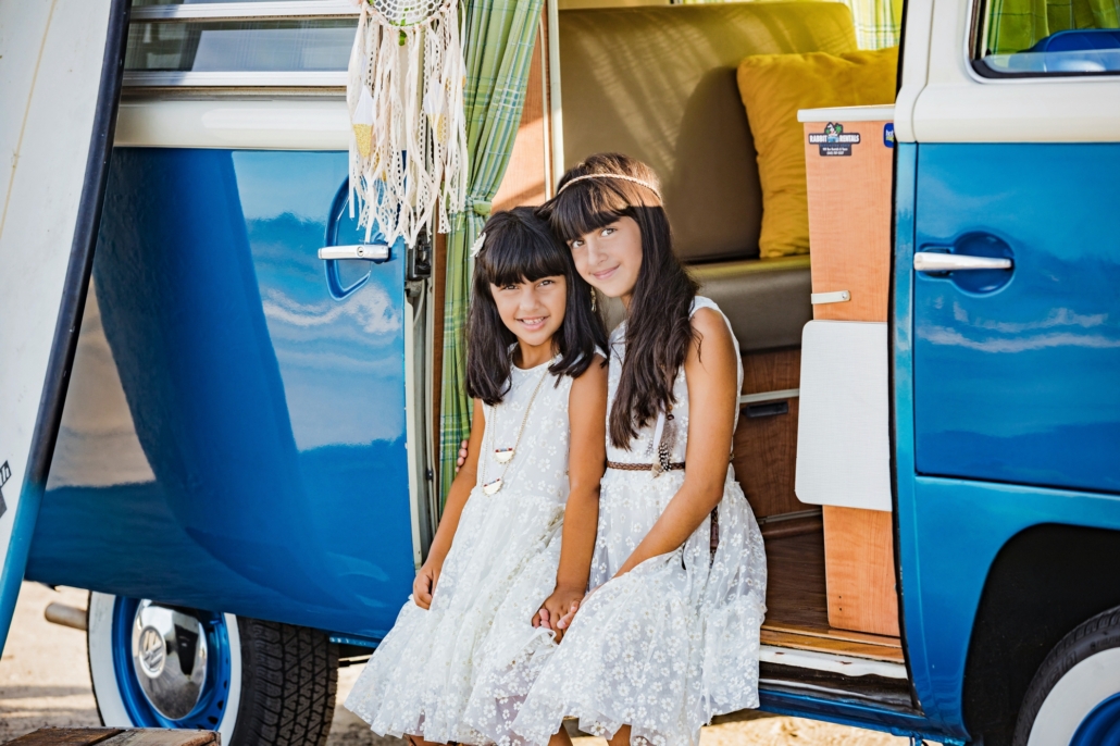 Sisters in a vintage VW van for a family portrait session
