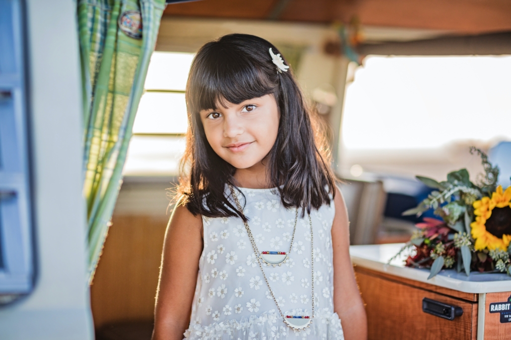 Portrait of a young girl in a vintage VW van in Huntington Beach CA