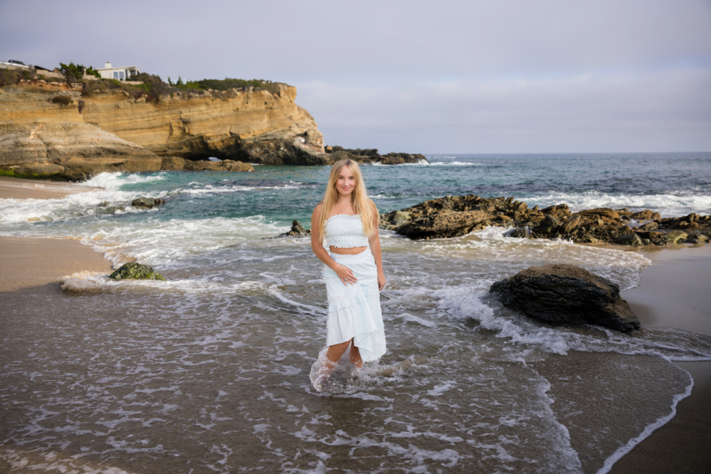 High school senior portrait session at Tablerock beach as the tide moved in. Blue Sky's Studio photographed this senior with her toes in the sand as the water swirled around her. 