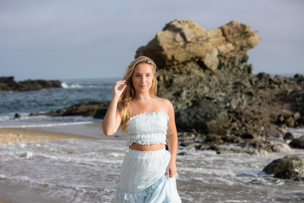 Photo session at Tablerock beach in Laguna Beach for a class of 2024 high school senior. She wore the perfect outfit of a tube top and flowy skirt in soft turquoise to match the ocean color.