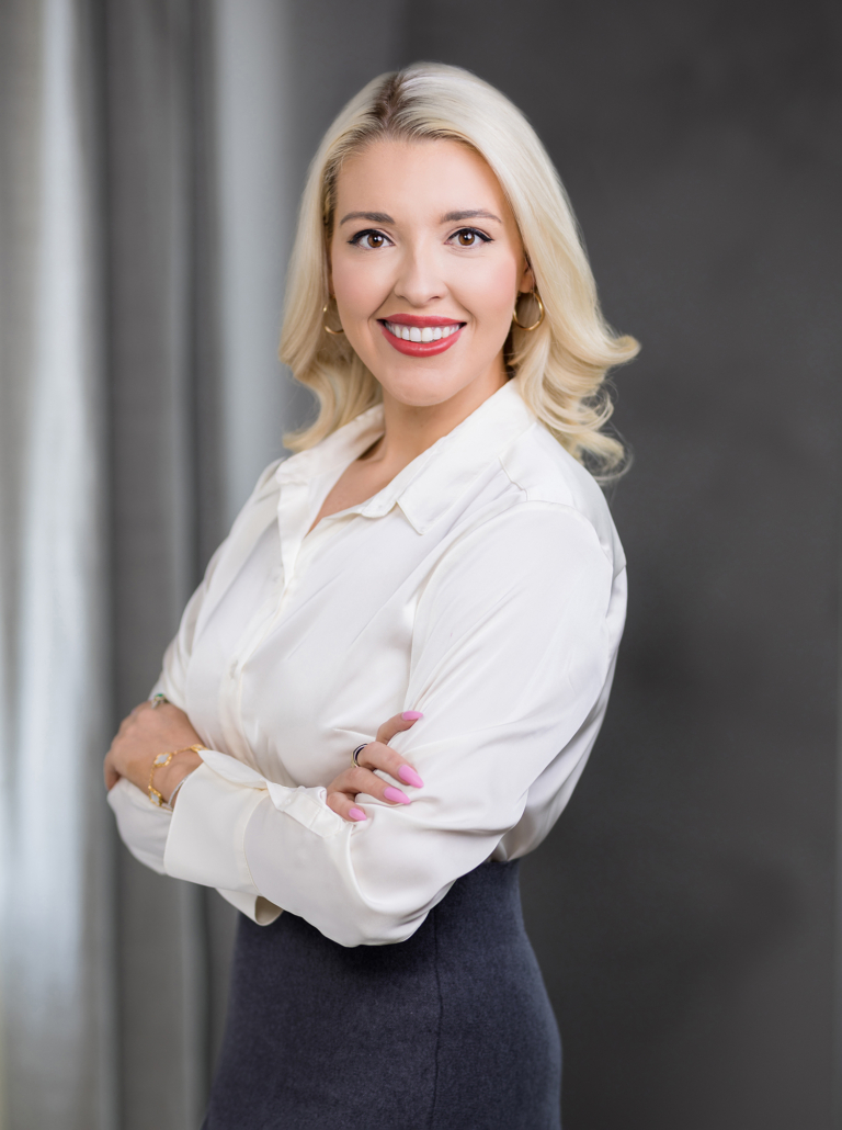 Executive woman with a bold makeup look with an emphasis on red lipstick. This is a clean, modern look for a headshot photography session.