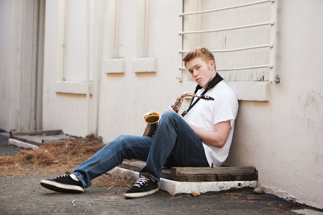 What to wear for a senior portrait session in an urban location if you are a musician. Incorporating a instrument in the session makes it stand out. 