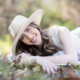 An image of what to wear to a senior session including accessories such as a hat and chunky jewelry. Image taken in Laguna Canyon in a field.