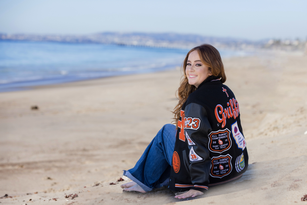 What to wear to a senior photo shoot at the beach including incorporating your letterman jacket