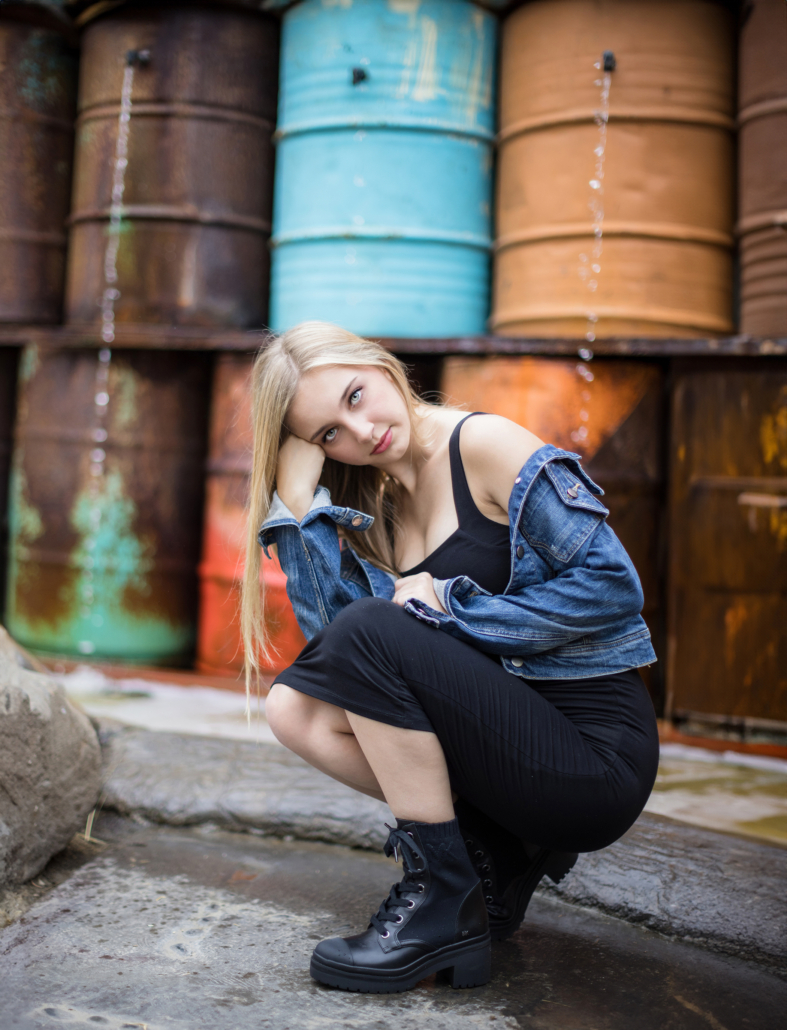 Senior portrait in front of a vintage barrel fountain at The Camp Anti-Mall