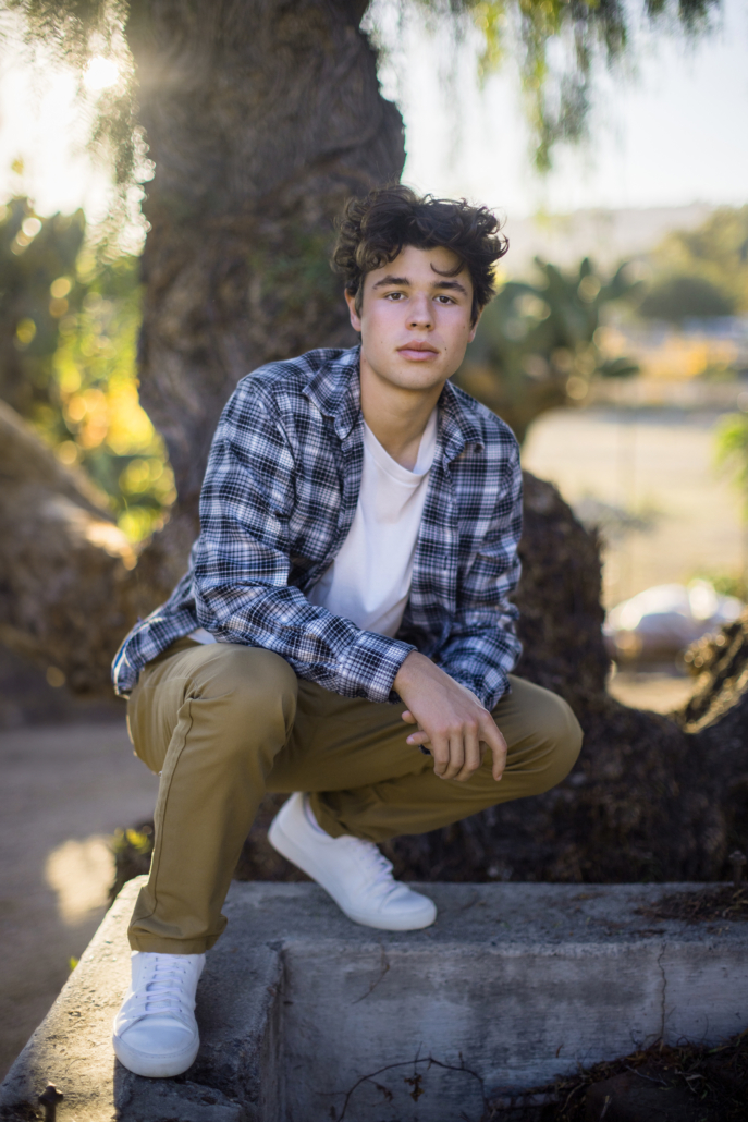 San Juan Capistrano is the pefect place for a senior urban session. This senior is wearing a flannel shirt and khaki pants which work great in this location.