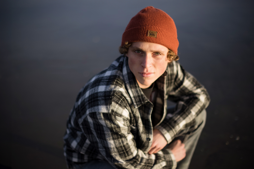 Senior portrait session at Bolsa Chica State Beach, capturing the graduate's excitement and coastal vibes