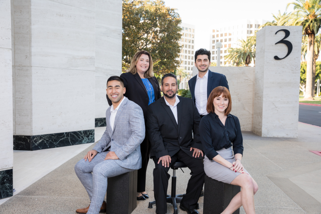 In this image we capture the executive team headshots in front of their office building.