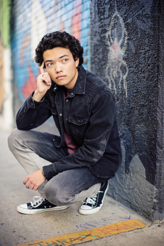 Vibrant senior portraits amidst Santa Ana's Art District's colorful murals and urban charm. 