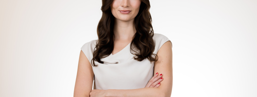 Professional woman in white blouse against a clean white studio backdrop