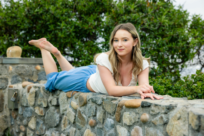 laguna-beach-senior-pictures-heisler-park-08 High school senior at photo session in Laguna Beach posing on a stone wall