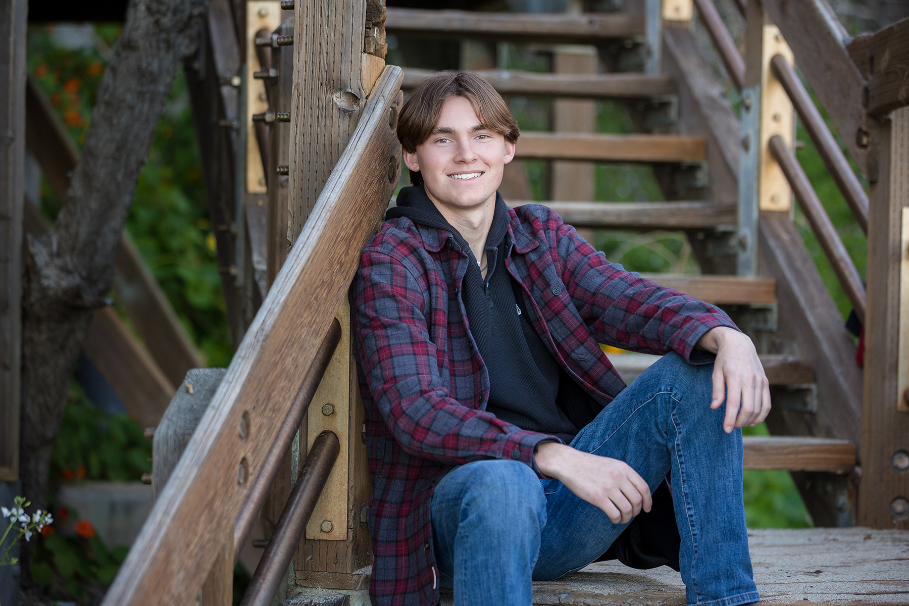 Senior guy in neutral colored layers for his senior portraits.