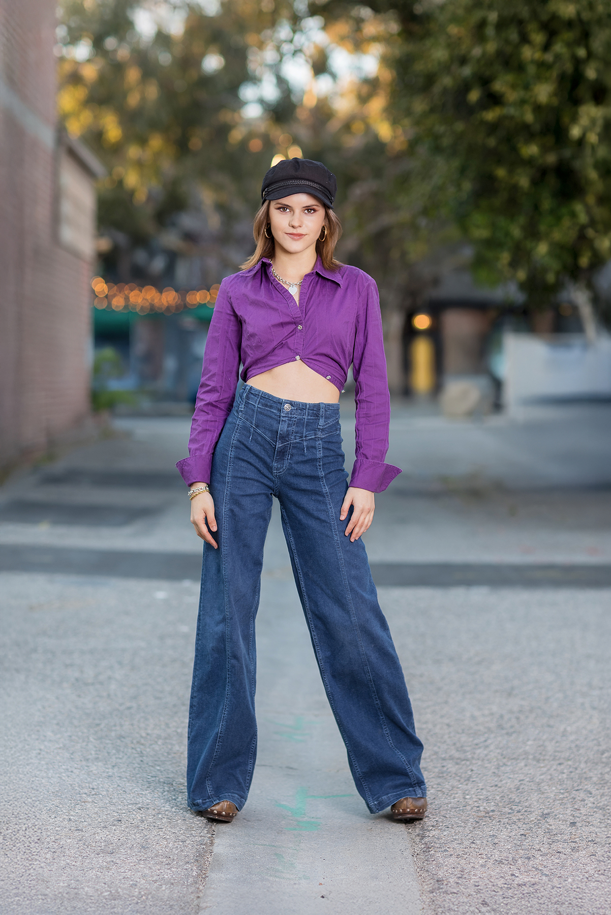 Senior portrait outfit details, including booties and simple jewelry.
